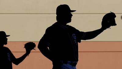 San Diego Padres pitchers Tayron Guerrero, left, and Leonel Campos catch during spring training baseball practice in Peoria, Ariz. Charlie Riedel / AP Photo