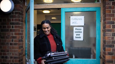 A member of staff from a school picks up repaired computers from Catbytes. AFP