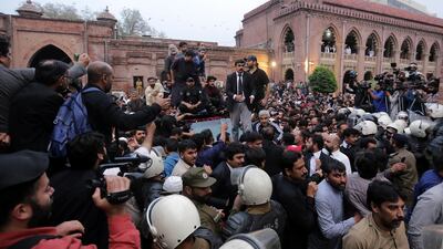Supporters and security guards surround former Pakistan prime minister Imran Khan's vehicle at Lahore High Court on Friday. EPA