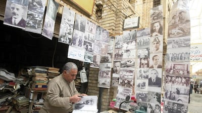 A bookseller at his stall in Baghdad’s Shorja market. Iraqi author Sinan Antoon, below, is working on a book that revolves around such a character. Ahmad Al Rubaye / AFP; Pawan Singh / The National