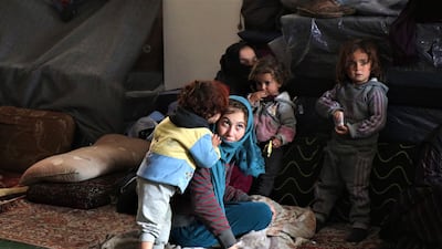 Syrian women play with their children after reaching the mosque. EPA