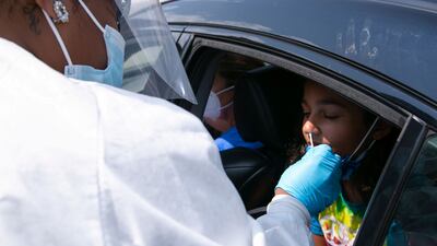 Nurse Celeste Moore, tests 11.5 years old Samira Javed for coronavirus at Seneca High School a day before returning to school in Louisville, Kentucky, US, on August 10, 2021. Reuters