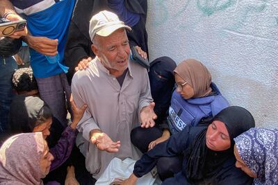Riyad Dagga prays over the body of his daughter, Mariam, during her funeral. Dagga family / AP