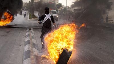 Palestinians burn tyres during clashes with Israeli troops near Ramallah in the occupied West Bank. Majdi Mohammed/AP Photo