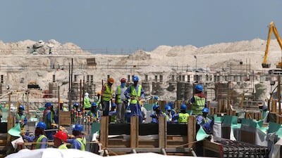 Workers at the site where the Lovure Abu Dhabi is being constructed. Marwan Naamani / AFP