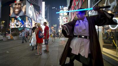 Star Wars fan Mike Deguzman practices with a toy lightsaber after purchasing some new toys in New York. Carlo Allegri / Reuters