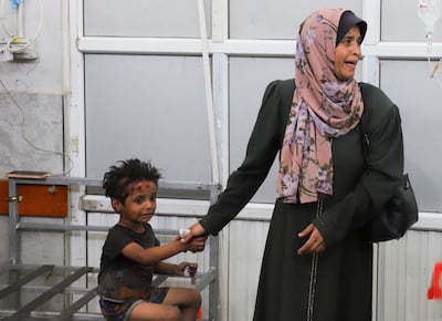 A Palestinian woman and child wait to receive treatment at Al Shifa Hospital in Gaza city on Monday. Reuters