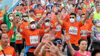 Runners with masks on compete in the annual Beijing Marathon. (Chi Ben / EPA)