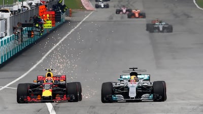 Max Verstappen, left, passes Lewis Hamilton, right, on his way to winning the Malaysian Grand Prix. Lai Seng Sin / Reuters