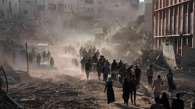 Palestinians return to the eastern side of Khan Younis after Israeli forces pulled out from the area, in the southern Gaza Strip. Reuters