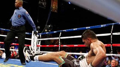Amir Khan is dumped to the canvas by a blow from Danny Garcia (not pictured) during their unification bout in Las Vegas