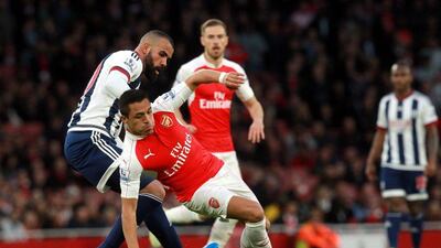 Arsenal’s Alexis Sanchez, centre, and West Brom’s Sandro in action. Sean Dempsey / EPA