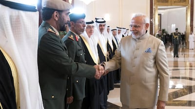 ABU DHABI, UNITED ARAB EMIRATES - February 10, 2018: HE Staff Major General Juma Al Bowardi, Commander of the UAE Armed Forces Land Forces (2nd R), receives HE Narendra Modi Prime Minister of India (C), at the Presidential Airport. seen with HE Lt General Hamad Thani Al Romaithi, Chief of Staff UAE Armed Forces (3rd L), HE Zaki Anwar Nusseibeh (4th L),HE Ali Mohamed Hammad Al Shamsi, Deputy Secretary-General of the UAE Supreme National Security Council (5th L) and others. ( Rashed Al Mansoori / Crown Prince Court - Abu Dhabi ) ---