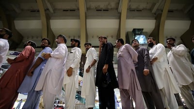 Shopkeepers queue to receive a dose of the Pak Vac vaccine at a shopping mall in Peshawar, Pakistan. EPA