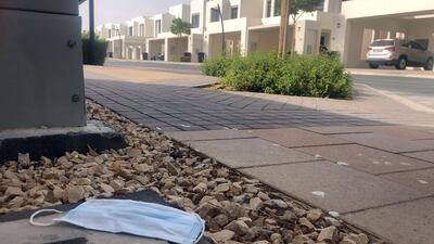 Discarded masks can leach chemicals into the ground. Chris Whiteoak / The National