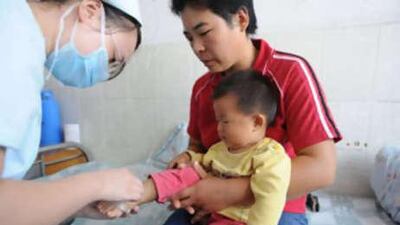A young Chinese child undergoes treatment at a hospital after taking tainted milk powder.