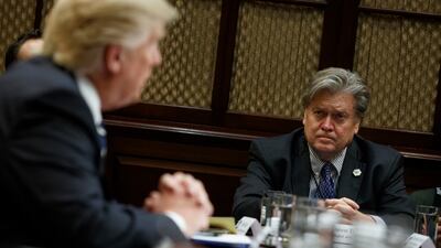 Mr Bannon listens as Mr Trump speaks during a meeting on cyber security in the Roosevelt Room of the White House in 2017. AP