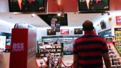 A man watches Michael Jackson perform in a video played at Virgin Records in Dubai.