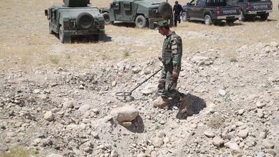 An Afghan security official looks for landmines in the Chaparhar district of Nangarhar province, Afghanistan, on 9 July 2019. EPA