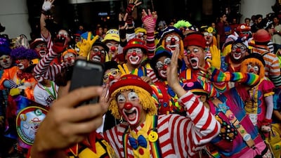 Clowns pose for a selfie after a parade during the Clown Festival.