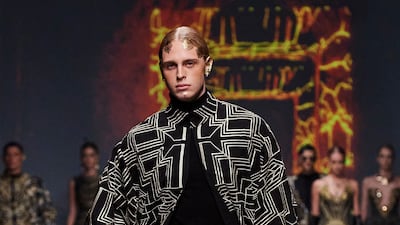 A model in flowing cape with geometric golden lines opened the show.