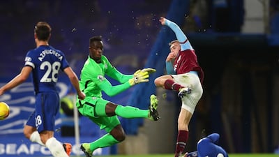 Chelsea goalkeeper Edouard Mendy attempts a save on West Ham's Jarrod Bowen. Reuters