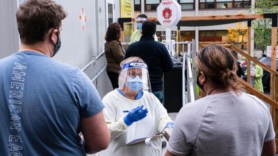 A nurse greets people at a Covid-19 walk-in clinic in Montreal. The Canadian Press via AP