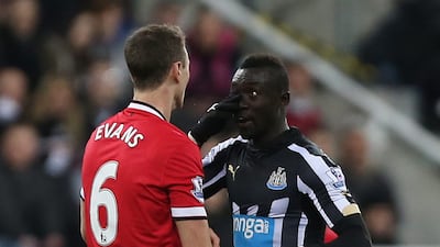 Manchester United's Jonny Evans clashes with Newcastle's Papiss Cisse. Reuters
