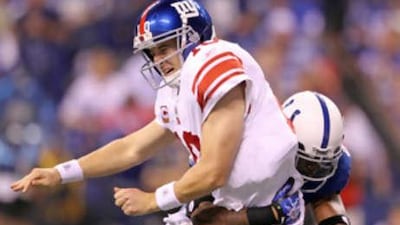 The Giants' Eli Manning, No 10, had very little chance against the Colts.