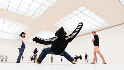 Visitors at the Museum of Contemporary Art (MOCA) in Los Angeles observe the performers of Xu Zhen's piece In Just a Blink of an Eye, on view until September 1. Myles Pettengill