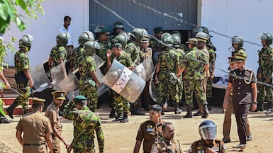 Sri Lankan personnel stand guard outside the Negombo prison after deadly clashes between inmates. AFP