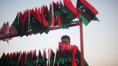 Mustafa Aojli, 21, prepares pre-Gadhafi flags for sell at the rebel-held town of Benghazi, Libya, Monday, Aug. 22, 2011. World leaders said Monday the end is near for Moammar Gadhafi's regime and began looking at Libya's future without the man who has held power there for 42 years. (AP Photo/Alexandre Meneghini)