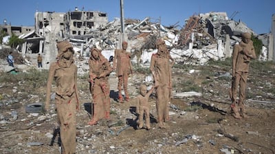 Statues by Palestinian artist Eyad Sabbah, 40, stand amidst the rubble of buildings destroyed during the 50 days of conflict between Israel and Hamas last summer, in the Shejaiya neighborhood of Gaza City. The statues are made of fiberglass and covered with clay and are depictions of the Palestinians who fled their houses from Israeli shelling during the most recent conflict. Mahmud Hams / AFP