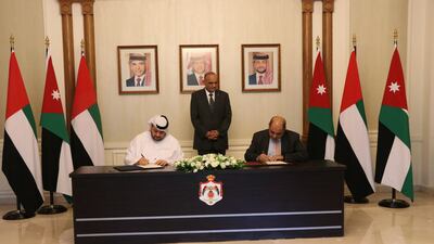 Jordanian Prime Minister Bisher Al Khasawneh, centre, looks on as Mohamed Alsuwaidi, managing director and chief executive of ADQ, left, and Ahmad Al Hanandeh, Jordan’s Minister of Digital Economy and Entrepreneurship, sign the pact. Photo: ADQ