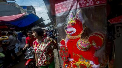 People walk past a kiosk selling Chinese decorations in Jakarta. Bay Ismoyo / AFP Photo