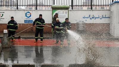 Firefighters wash the site of a suicide attack which targeted the entrance gate of Marshal Fahim Military Academy in Kabul, Afghanistan. EPA