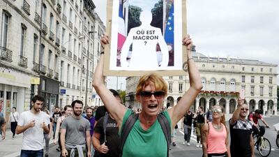 A protestor with an image of French President Emmanuel Macron during an environmental protest in in Bayonne, near Biarritz, on the second day of the G7 summit. EPA