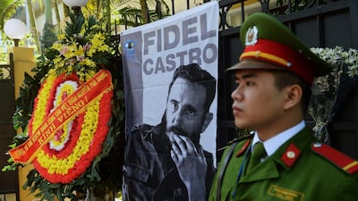 A wreath from the Communist Party of Vietnam is pictured next to a portrait of Fidel Castro in Hanoi on November 28, 2016. Hoang Dinh Nam / AFP