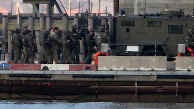US security troops lead Mr Maduro from the heliport. He has been president of Venezuela since 2013. Reuters