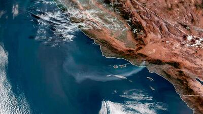 This satellite image from the US National Oceanic and Atmospheric Administration shows a plume of smoke from the Saddleridge wildfire streaming out over the Pacific Ocean. AP