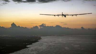 Solar Impulse 2, a plane powered by the sun's rays and piloted by Andre Borschberg, approaches Kalaeloa Airport near Honolulu. The team has been revitalised by their world record-breaking flight from Japan to Hawaii on Friday. Jean Revillard / AP
