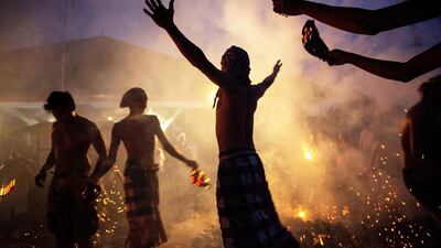 Balinese men hit each other during the “Mesabatan Api” ritual a head of Nyepi Day in Gianyar, Bali, Indonesia. Agung Parameswara / Getty