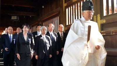A Shinto priest, right, leads a group of Japanese politicians to offer prayers for the country's war dead at the controversial Yasukuni Shrine in Tokyo.