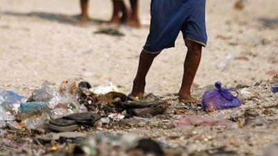 Filipino children working by collecting sand at a shore line in the Manila suburbs. Underage children are being forced to manual labor to help their families mainly due to poverty.
