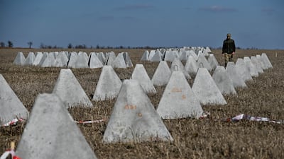 Danylo, commander of an engineering and sapper company of the Ukrainian Armed Forces, inspects pyramidal anti-tank obstacles known as 'dragon's teeth' before installing them into a new fortification line in Zaporizhzhia region. Reuters