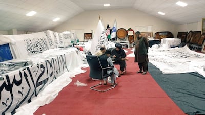 Unidentified people are surrounded by Taliban flags at an unidentified location, in this handout photo uploaded to social media. Reuters