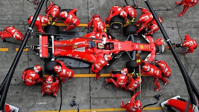 Ferrari’s Sebastian Vettel of Germany makes a pit stop for new tyres. Mark Thompson / Getty Images