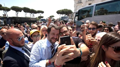 Leader of the League party and Italian Interior Minister, Matteo Salvini, poses for a photo as he walks through the crowd on the occasion of celebrations for Italy's Republic Day, in Rome Saturday, June 2, 2018. (Claudio Peri/ANSA via AP)
