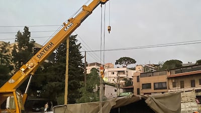 Work starts to pick up the lorry. Reuters