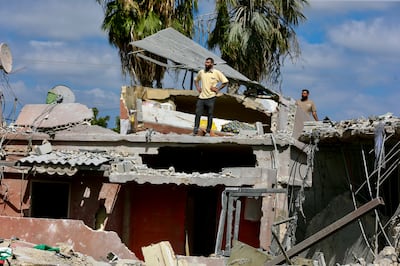 People inspect damage following an Israeli air strike in Lebanon's southern port city of Tyre. EPA